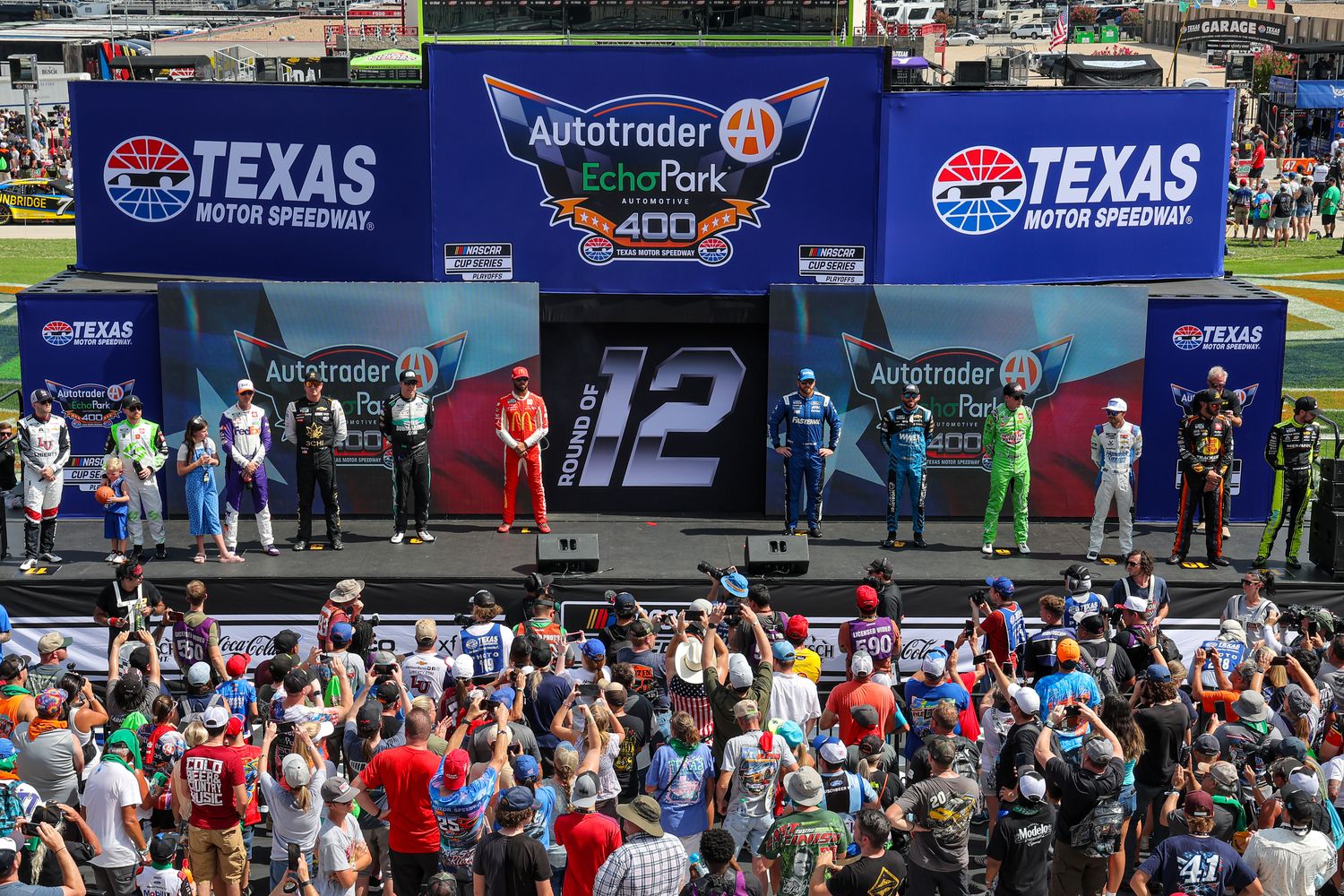 The NASCAR Cup Series Round of 12 playoff drivers pose onstage during driver intros prior to Sunday's NASCAR Cup Series Autotrader EchoPark Automotive 400 at Texas Motor Speedway. As it turned out afterward, four of those drivers now find themselves in trouble if they hope to advance to the next round. (Photo by Jonathan Bachman/Getty Images)